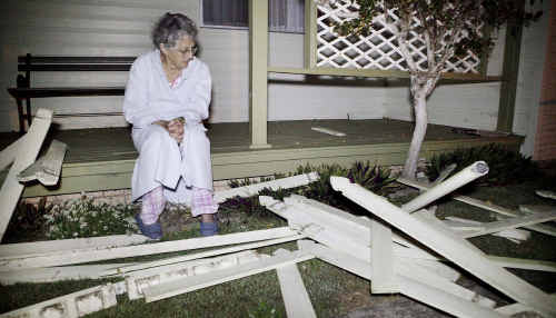 Red Rock resident Lois Russell inspects the damage after a car crashed into the front yard of her home on Tuesday night, while (inset) police allege the Ford Falcon driver fled the crash scene. Red Rock resident Lois Russell inspects the damage after a car crashed into the front yard of her home on Tuesday night, while (inset) police allege the Ford Falcon driver fled the crash scene.